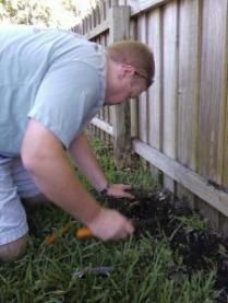 a Sprinkler Repair tech covers a newly installed pop up head